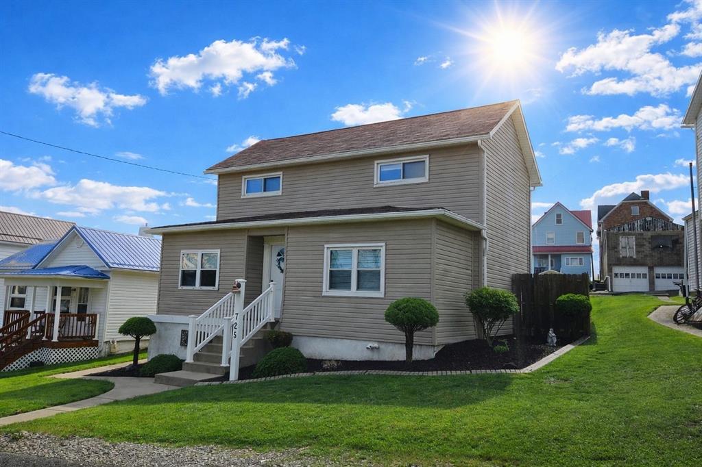 725 Longfellow Street Vandergrift, PA 15690 - Photo 2 of 14 a front view of a house with a yard and potted plants