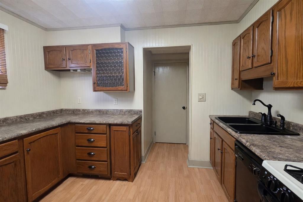 725 Longfellow Street Vandergrift, PA 15690 - Photo 5 of 14 a kitchen with granite countertop a sink a stove and cabinets