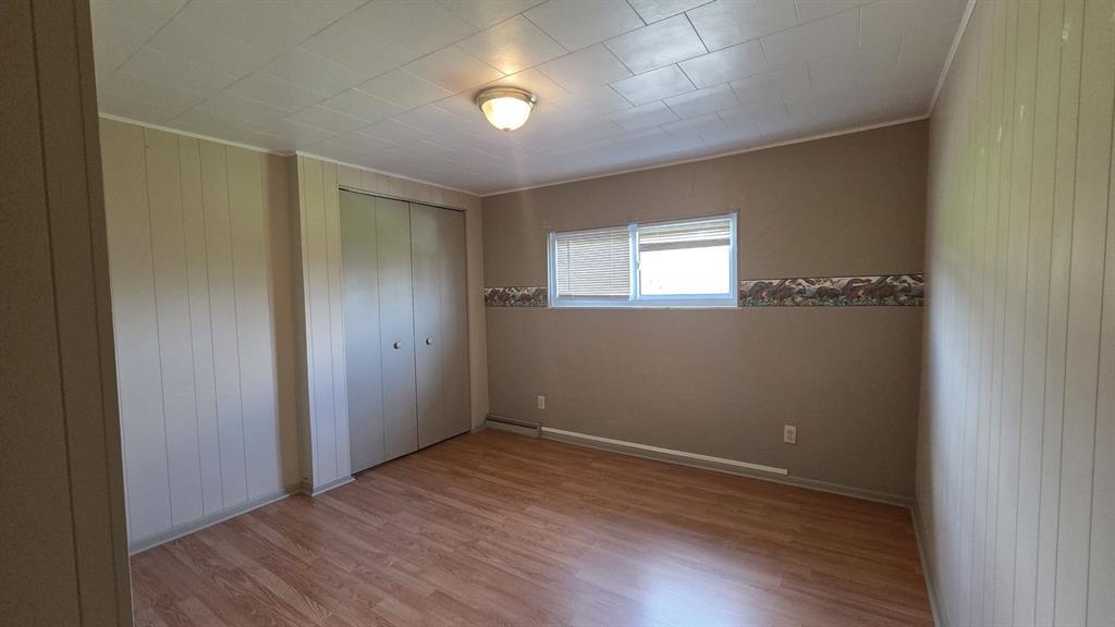 725 Longfellow Street Vandergrift, PA 15690 - Photo 6 of 14 a view of an empty room with wooden floor and a window