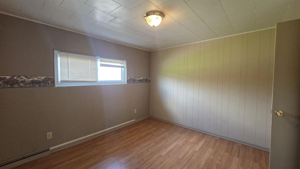 725 Longfellow Street Vandergrift, PA 15690 - Photo 7 of 14 an empty room with wooden floor and windows