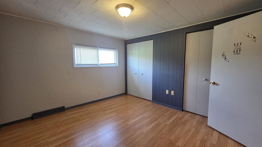 725 Longfellow Street Vandergrift, PA 15690 - Photo 9 of 14 a view of an empty room with wooden floor and a window