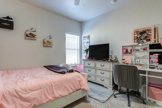 a bedroom with a bed and flat screen tv