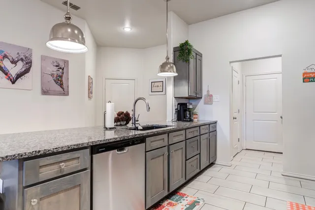 a kitchen with a sink and cabinets