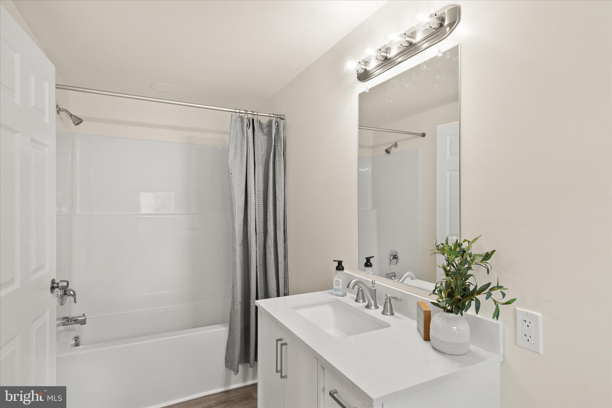 26465 Mason Webster Road Princess Anne, MD 21853 - Photo 20 of 56 a bathroom with a sink a mirror and a bathtub