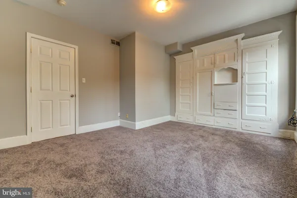 a view of an empty room and closet area