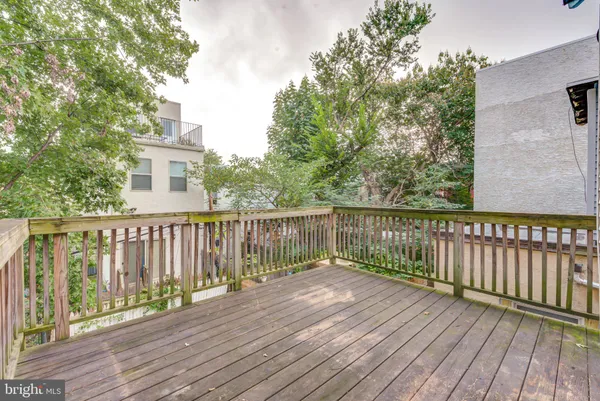 a view of a house with wooden deck