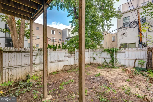 a view of a house with a yard and wooden fence