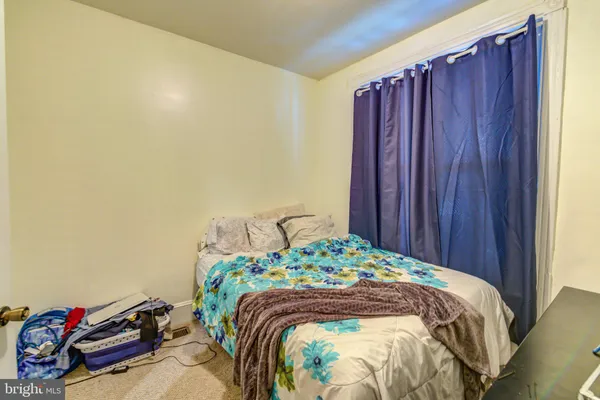 a bed sitting in a bedroom next to a wooden door