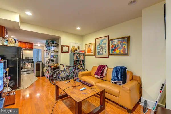 a living room with furniture a rug and a flat screen tv