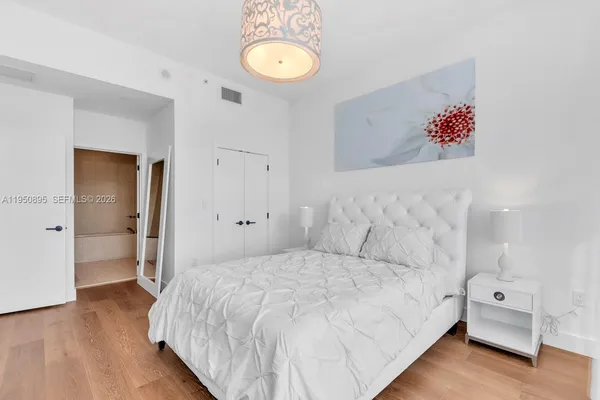 a bedroom with a bed and a lamp