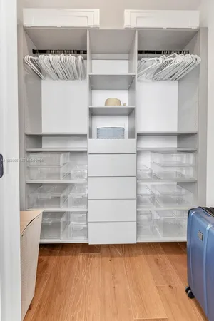 a view of walk in closet with empty racks