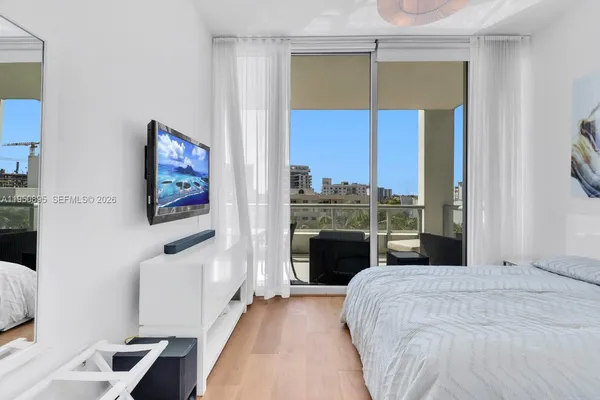 a bedroom with a bed and a television