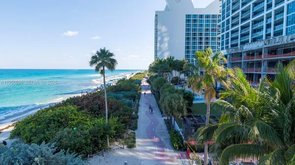 a view of a yard and an buildings in the background