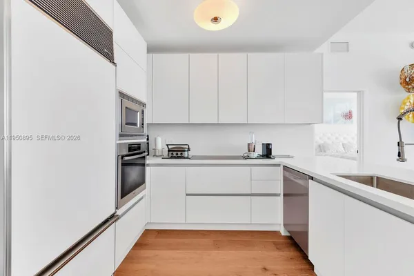 a kitchen with stainless steel appliances granite countertop a refrigerator and a sink