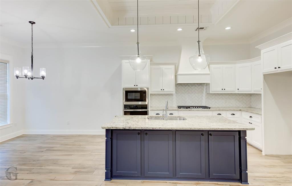605 Meridian Way Benton, LA 71006 - Photo 8 of 29 Kitchen island featuring a light-toned countertop and contrasting dark cabinetry
