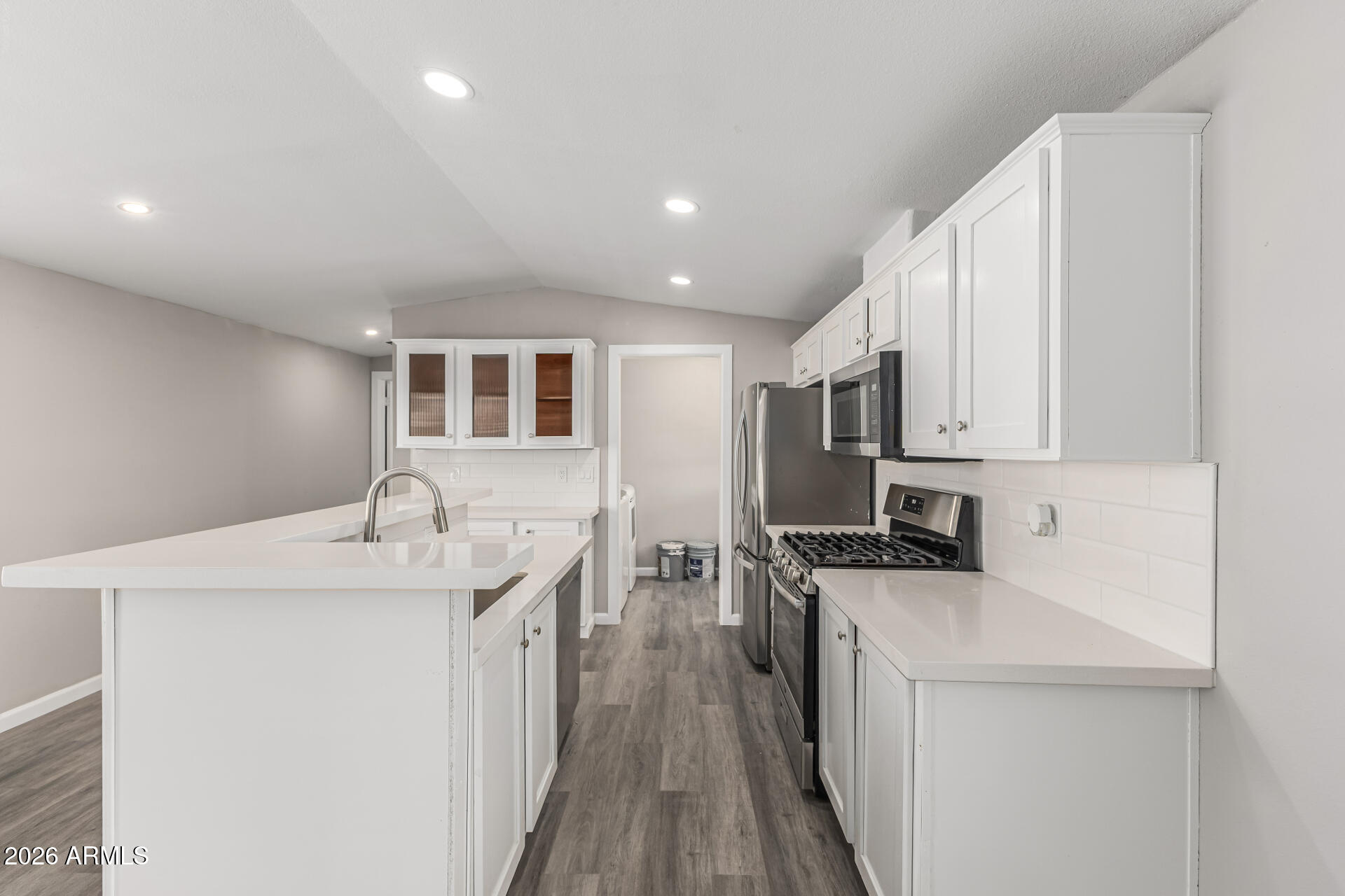 625 West McKellips Road, Unit 330 Mesa, AZ 85201 - Photo 12 of 46 a kitchen with stainless steel appliances granite countertop a sink stove and refrigerator