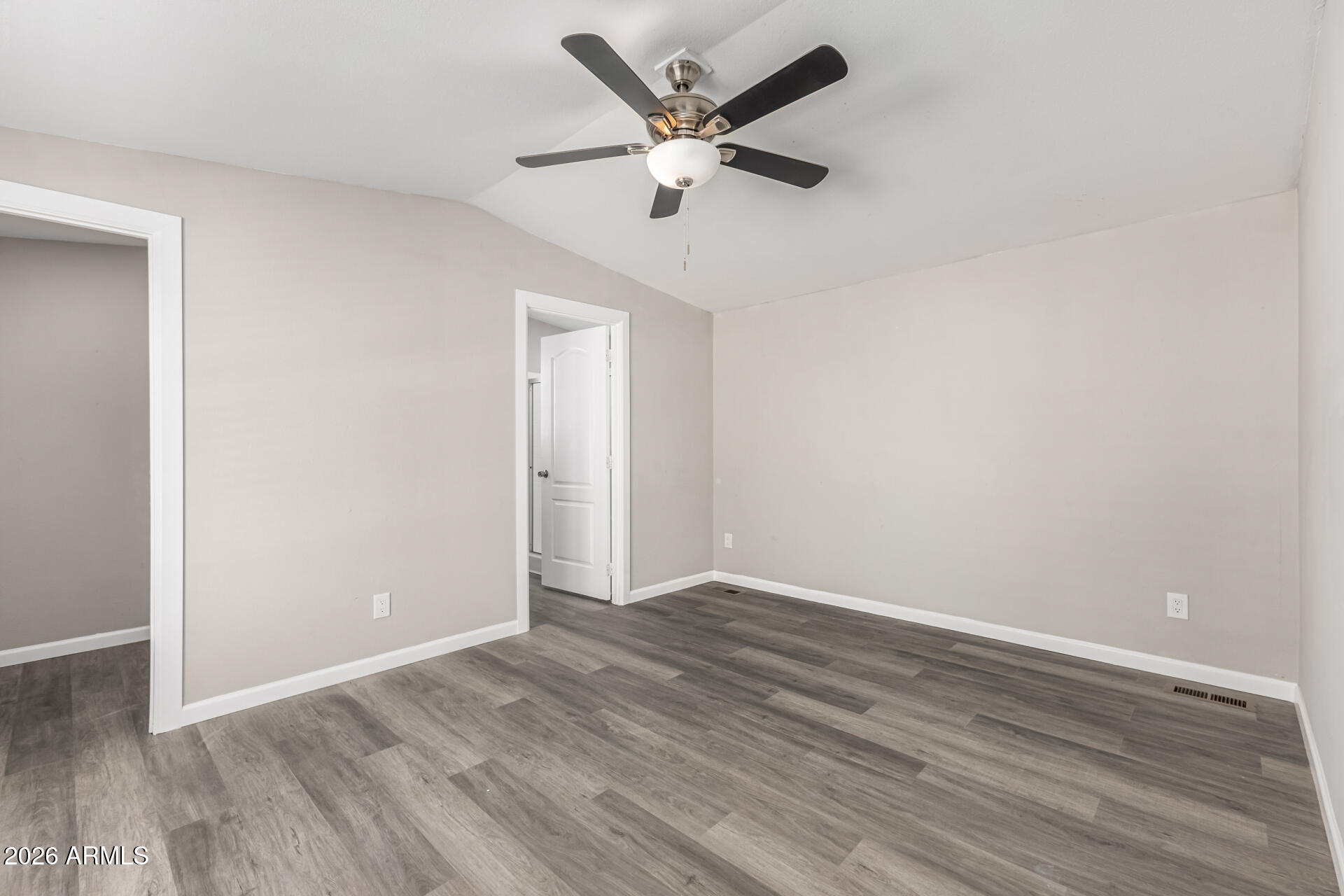 625 West McKellips Road, Unit 330 Mesa, AZ 85201 - Photo 13 of 46 an empty room with wooden floor and ceiling fan