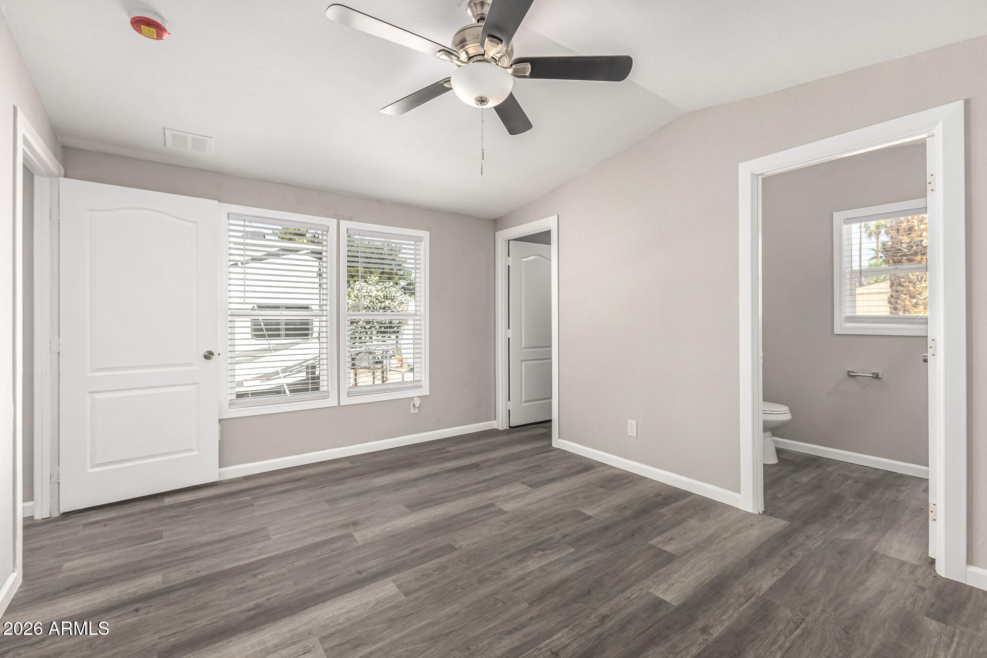 625 West McKellips Road, Unit 330 Mesa, AZ 85201 - Photo 15 of 46 a view of an empty room with wooden floor and a window