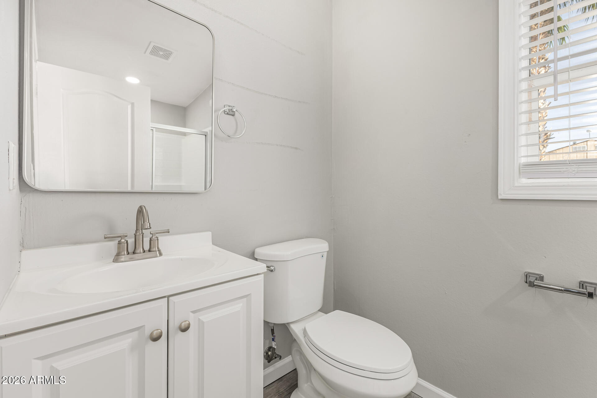 625 West McKellips Road, Unit 330 Mesa, AZ 85201 - Photo 16 of 46 a bathroom with a toilet sink vanity and mirror