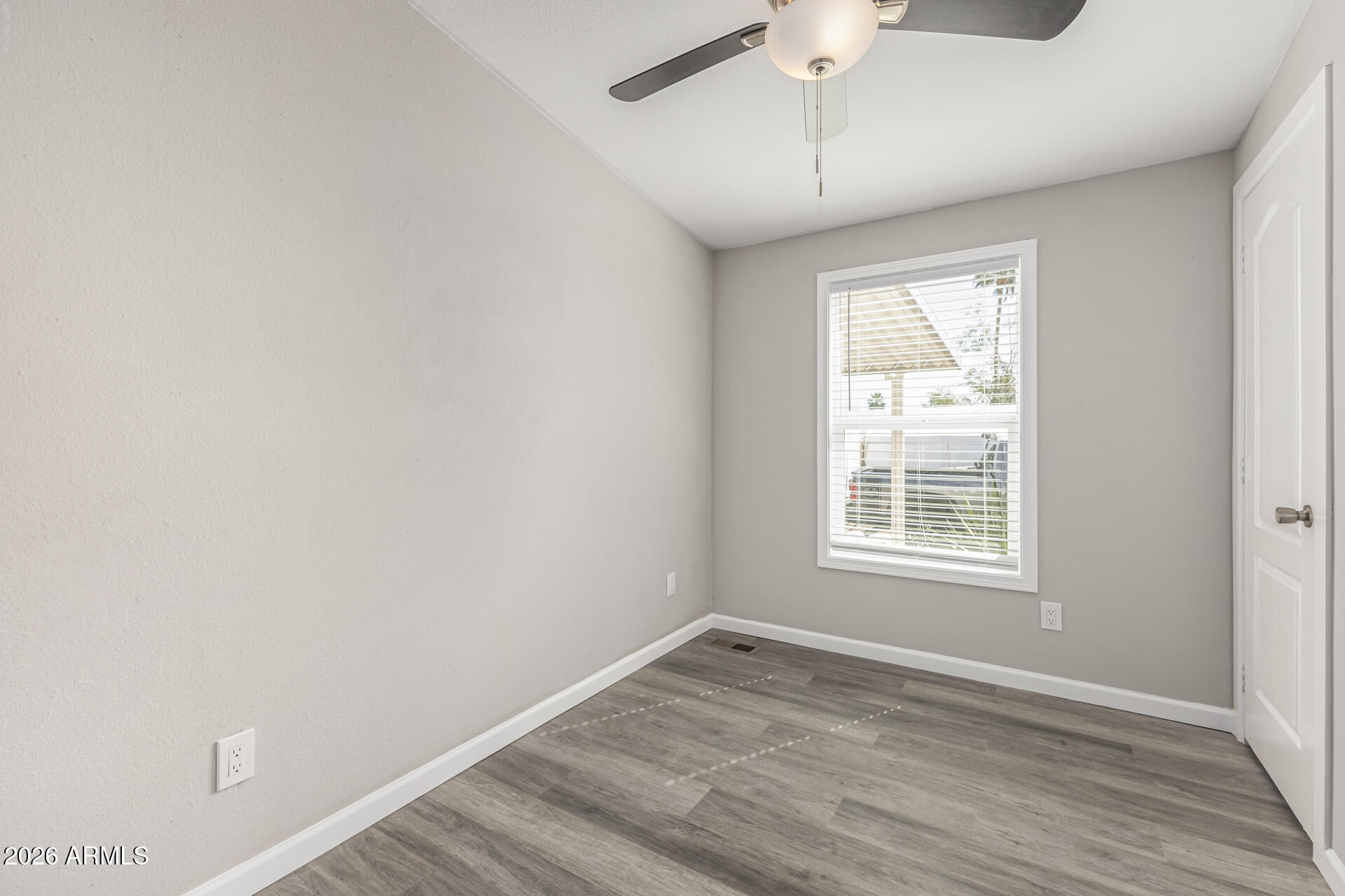 625 West McKellips Road, Unit 330 Mesa, AZ 85201 - Photo 18 of 46 an empty room with a window and wooden floor