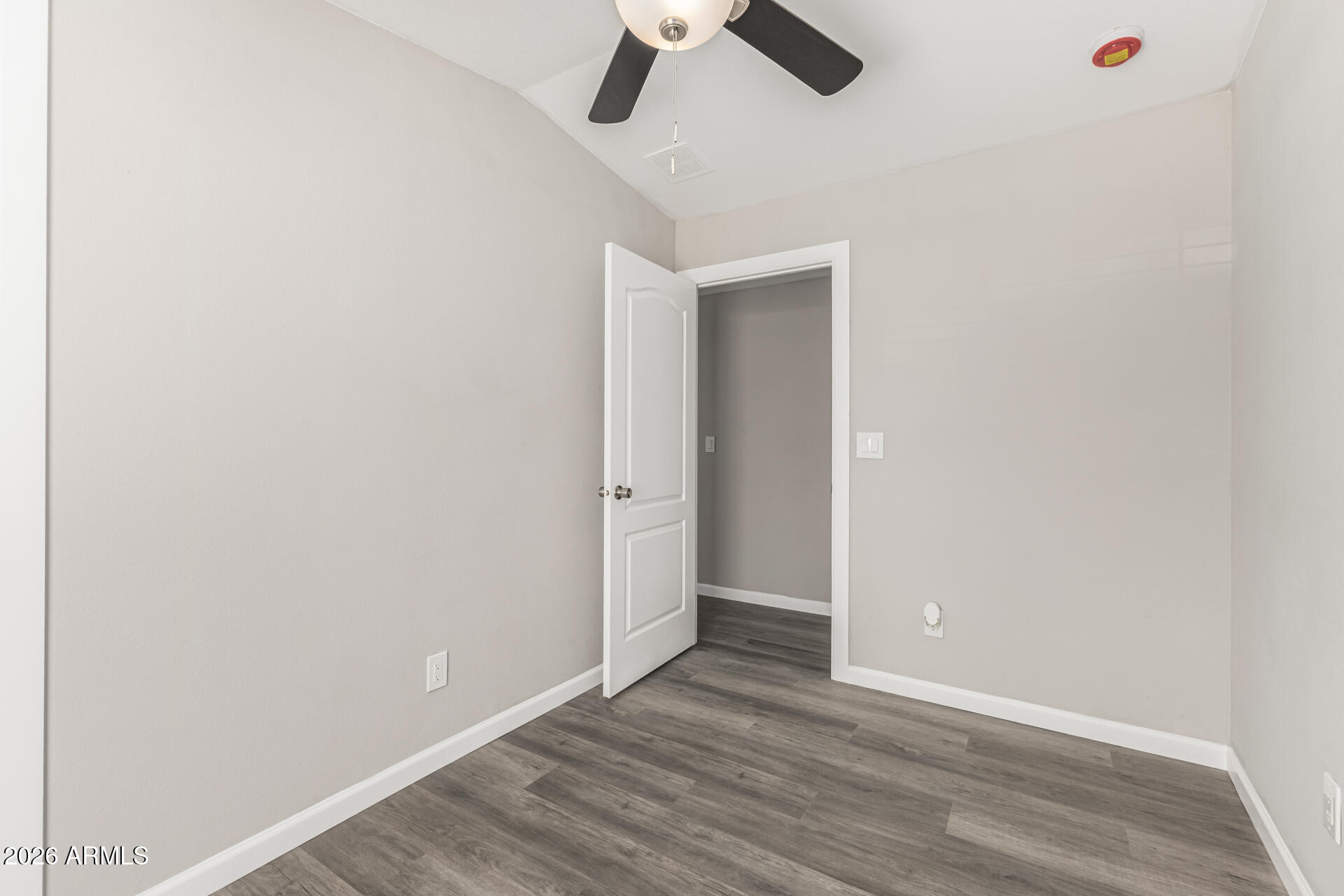 625 West McKellips Road, Unit 330 Mesa, AZ 85201 - Photo 19 of 46 an empty room with a ceiling fan and wooden floor