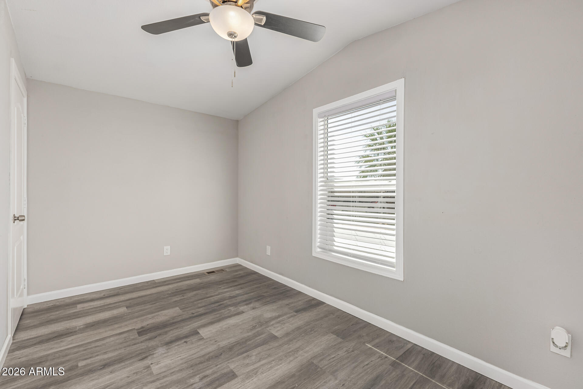 625 West McKellips Road, Unit 330 Mesa, AZ 85201 - Photo 20 of 46 a view of an empty room with wooden floor and a window