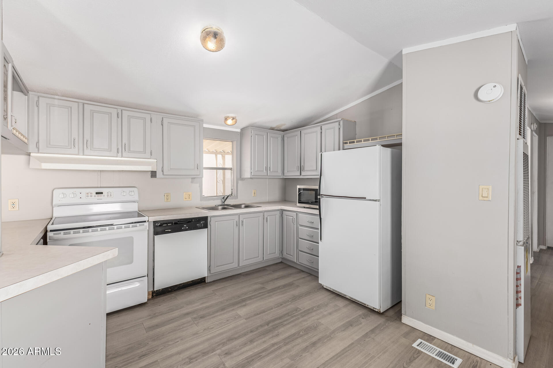 625 West McKellips Road, Unit 330 Mesa, AZ 85201 - Photo 26 of 46 a kitchen with white cabinets and white appliances