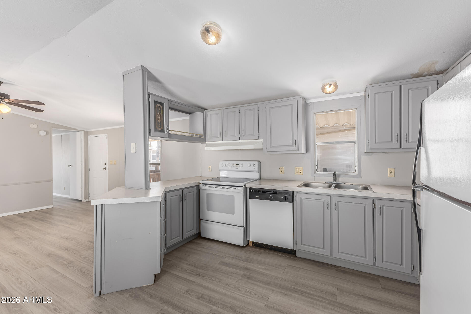 625 West McKellips Road, Unit 330 Mesa, AZ 85201 - Photo 27 of 46 a kitchen with white cabinets and white appliances