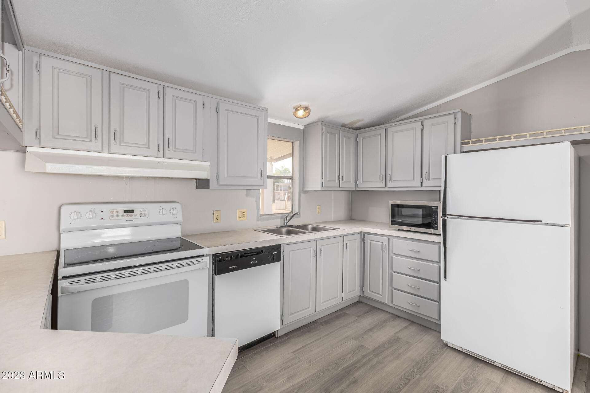 625 West McKellips Road, Unit 330 Mesa, AZ 85201 - Photo 28 of 46 a kitchen with cabinets appliances a sink and a counter space