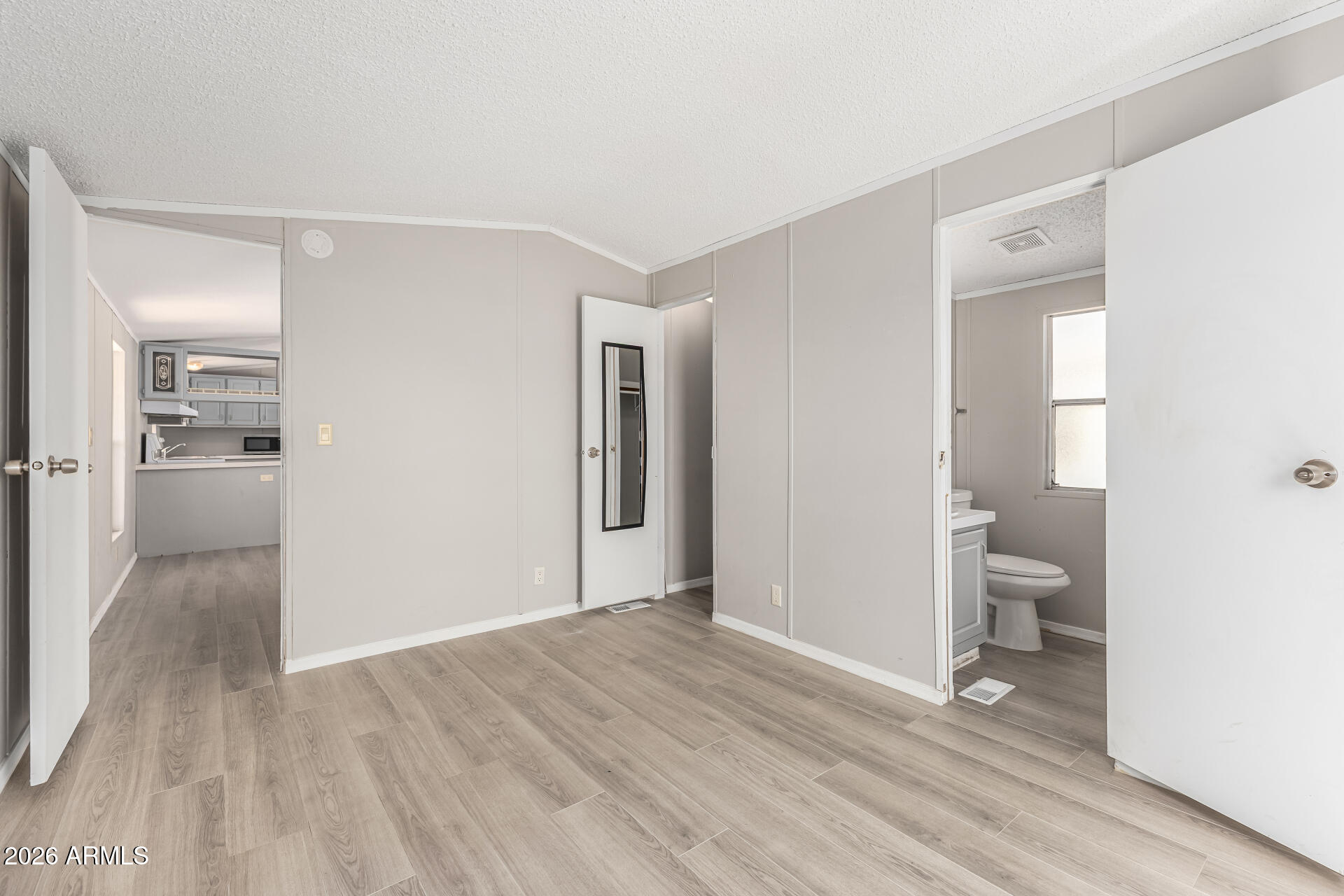 625 West McKellips Road, Unit 330 Mesa, AZ 85201 - Photo 31 of 46 a view of a hallway with wooden floor and a bathroom