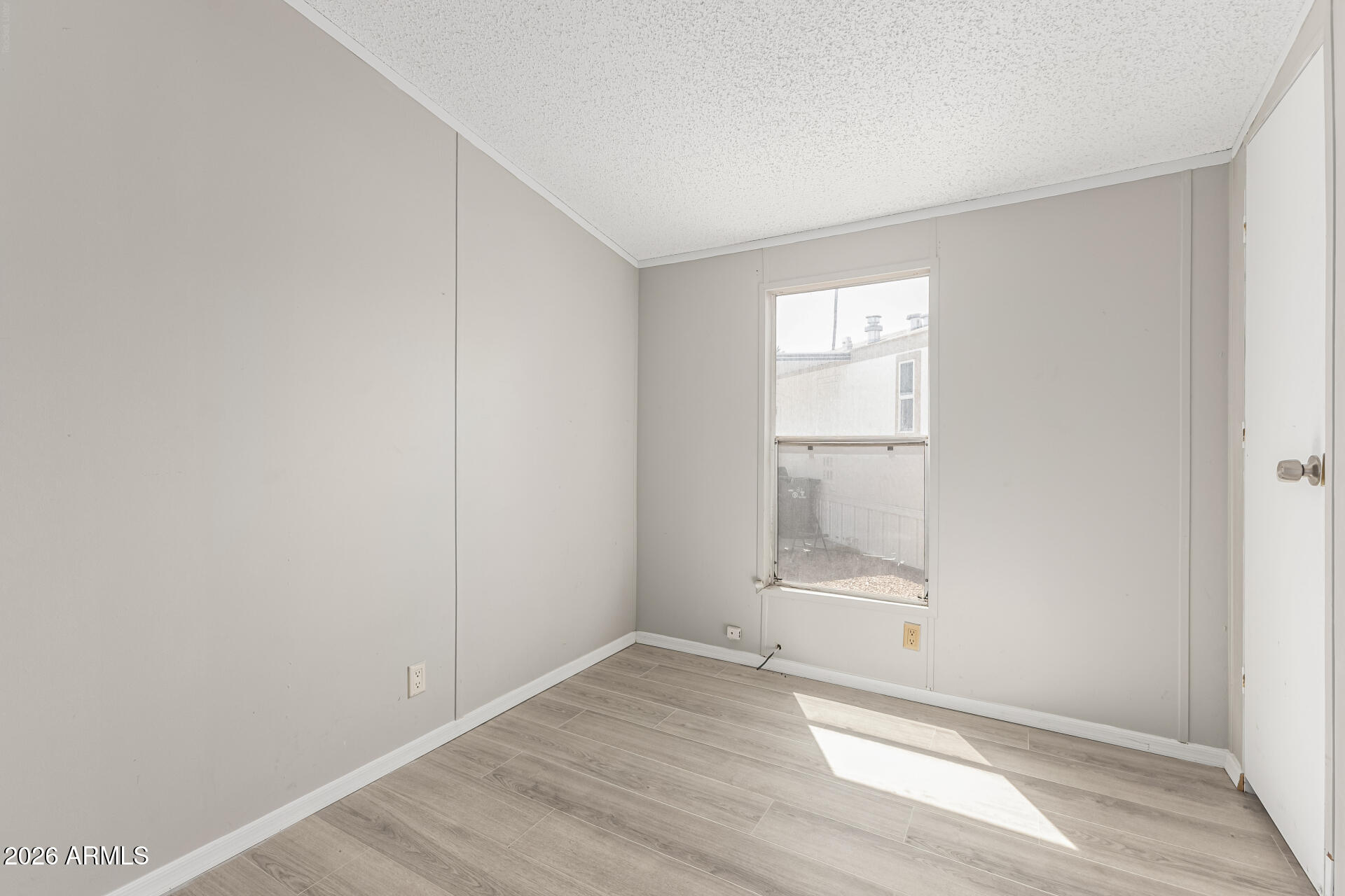625 West McKellips Road, Unit 330 Mesa, AZ 85201 - Photo 35 of 46 an empty room with wooden floor and windows