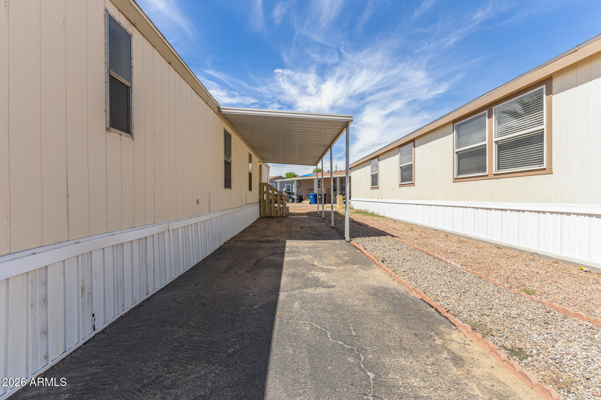 625 West McKellips Road, Unit 330 Mesa, AZ 85201 - Photo 6 of 46 a hallway with wooden fence and large windows