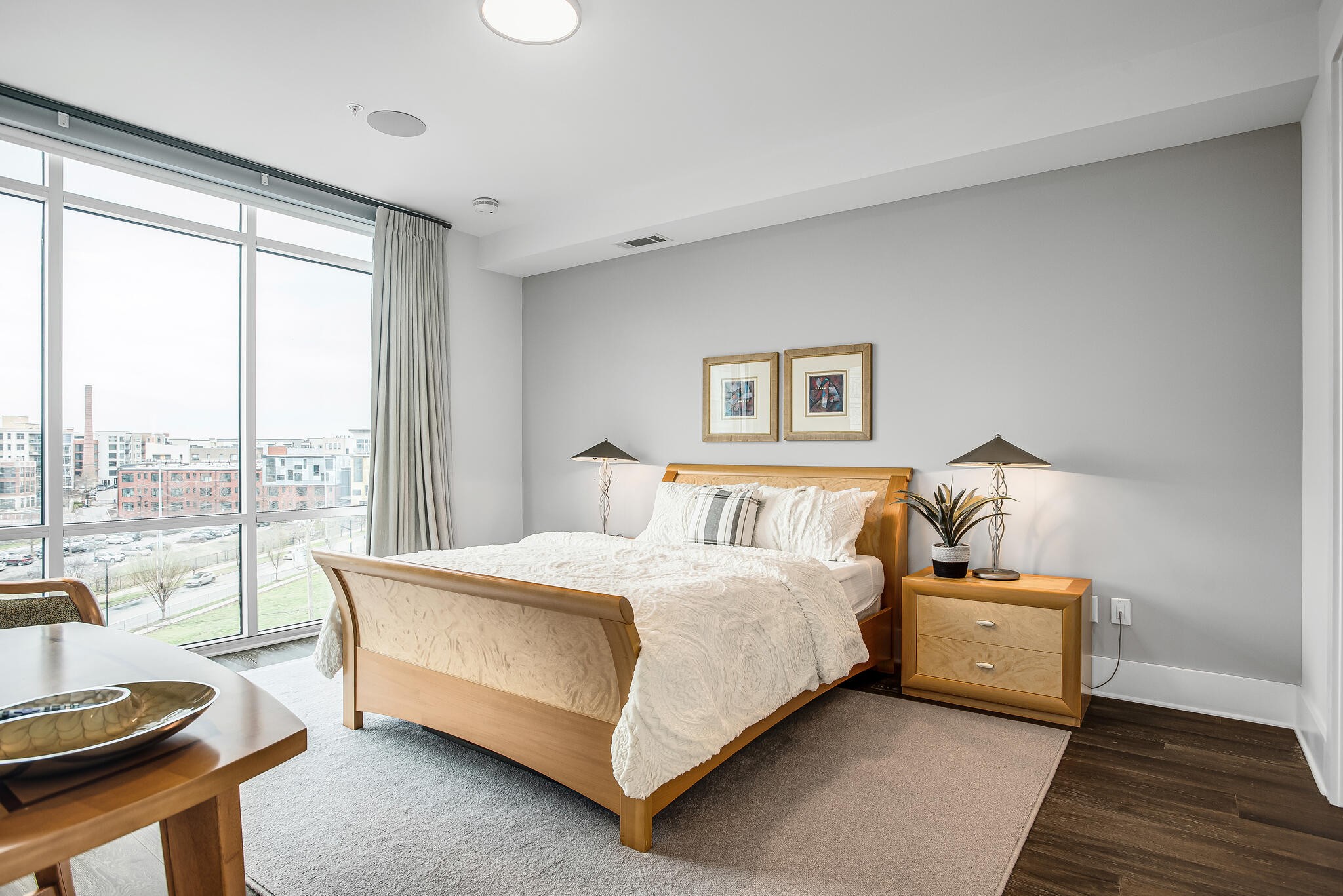 20 Rutledge Street, Unit 407 Nashville, TN 37210 - Photo 13 of 39 a bedroom with a bed and wooden floor
