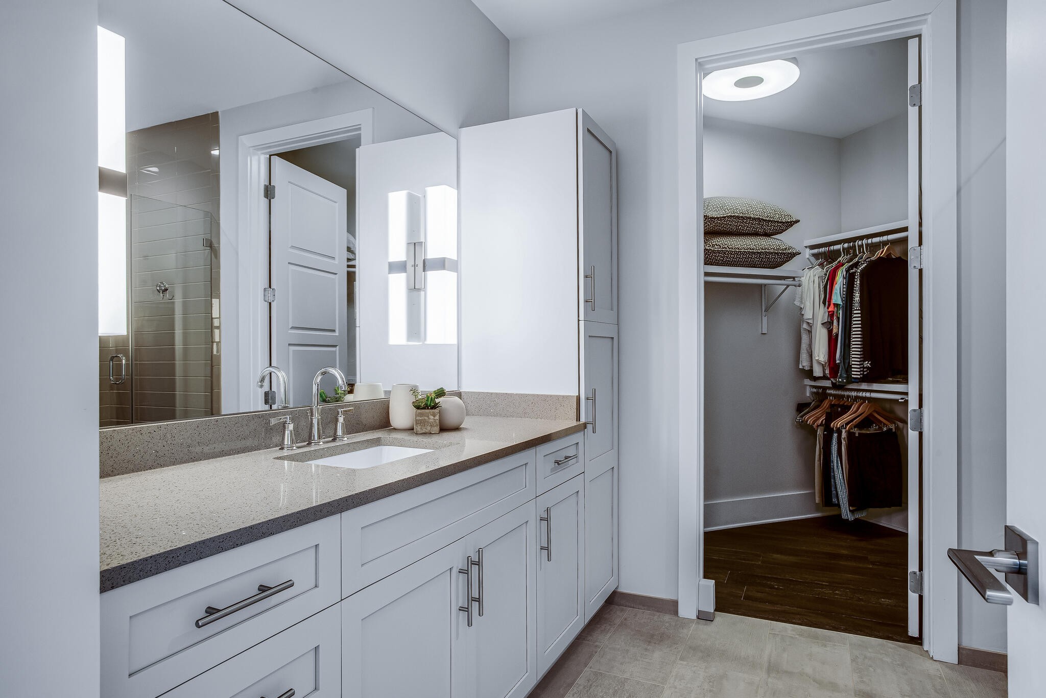 20 Rutledge Street, Unit 407 Nashville, TN 37210 - Photo 21 of 39 a en suite bathroom with a granite countertop sink and a mirror