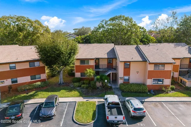 an aerial view of a house with swimming pool and patio