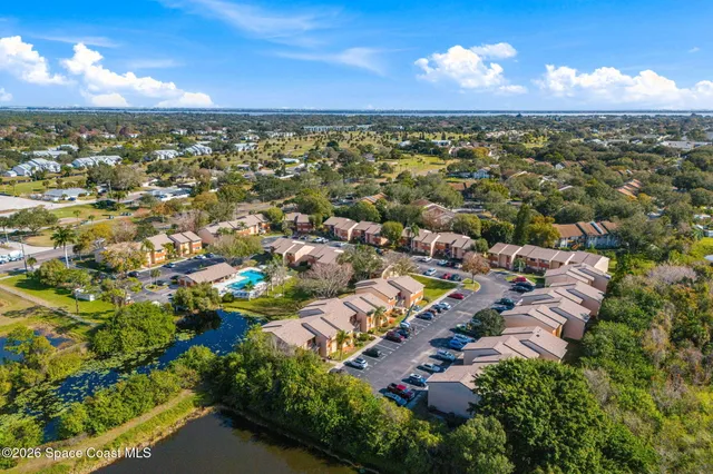 an aerial view of multiple houses with yard