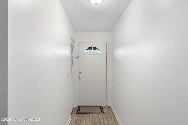 a view of a hallway with wooden floor