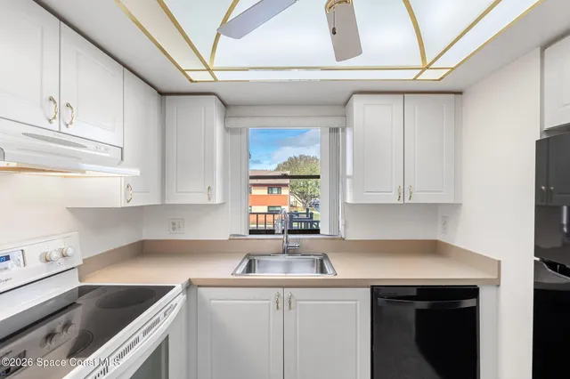 a kitchen with a sink cabinets and window