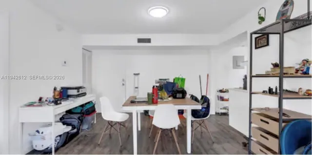 a view of a dining room with furniture and a potted plant