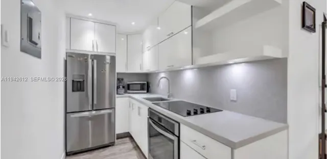 a kitchen with a stove a refrigerator and a sink