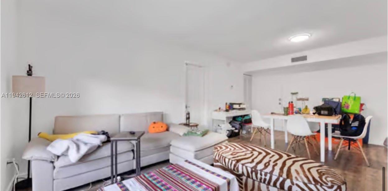 4841 Northwest 7th Street, Unit 3034 Miami, FL 33126 - Photo 17 of 35 a living room with furniture and a table