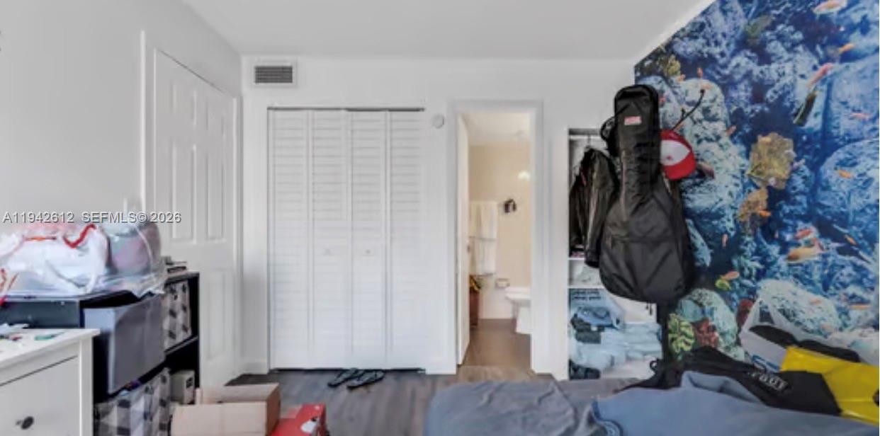 4841 Northwest 7th Street, Unit 3034 Miami, FL 33126 - Photo 21 of 35 a view of walk in closet with clothes