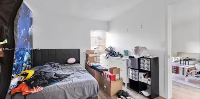 a bedroom with a bed and cabinets