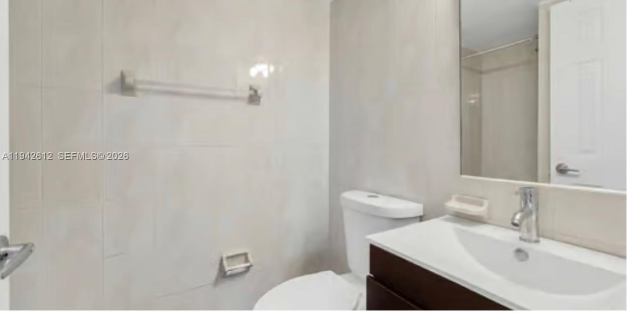 4841 Northwest 7th Street, Unit 3034 Miami, FL 33126 - Photo 24 of 35 a bathroom with a sink vanity and a toilet