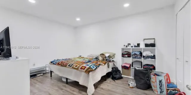 a bedroom with a bed and a bookshelf