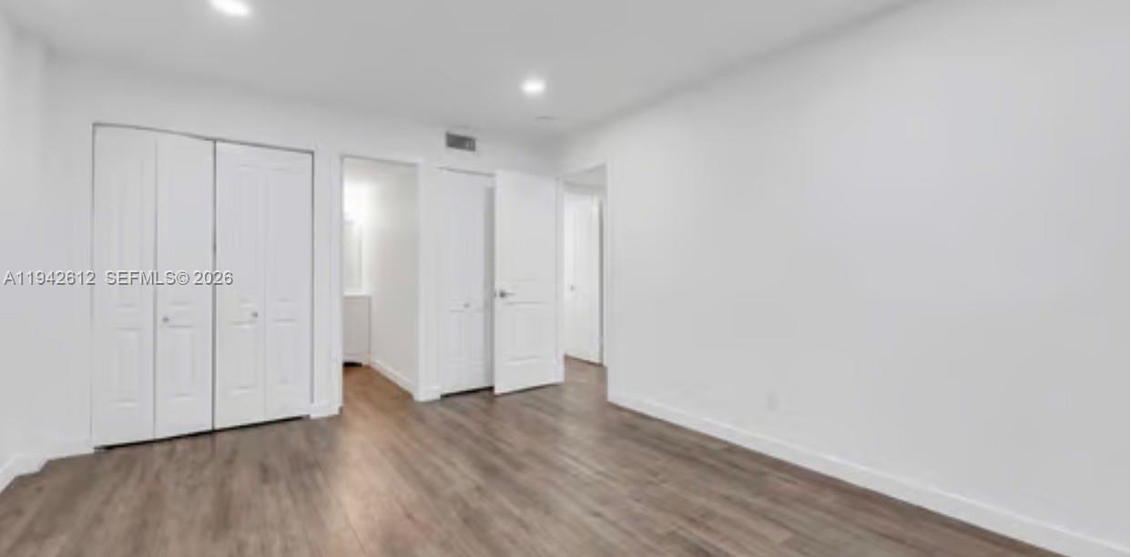 4841 Northwest 7th Street, Unit 3034 Miami, FL 33126 - Photo 30 of 35 a view of an empty room with wooden floor