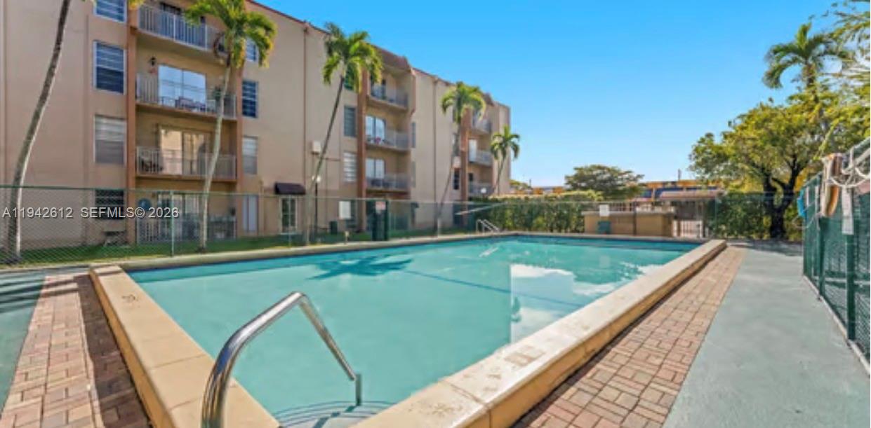 4841 Northwest 7th Street, Unit 3034 Miami, FL 33126 - Photo 3 of 35 a view of a swimming pool with a lake view