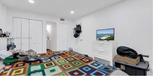 a bedroom with bed and a window