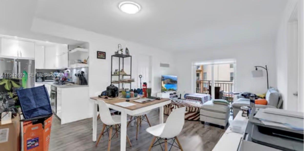 4841 Northwest 7th Street, Unit 3034 Miami, FL 33126 - Photo 9 of 35 a living room with furniture and a wooden floor