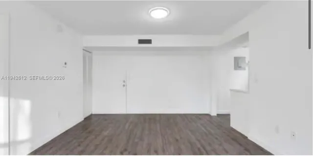 an empty room with wooden floor